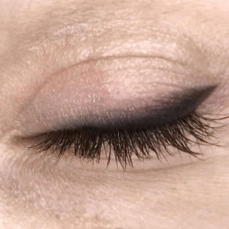 Permanent eyeliner result with soft shaded liner on a closed eye