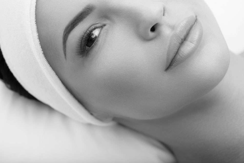 Close-up of permanent eyebrows on a relaxed client in black and white